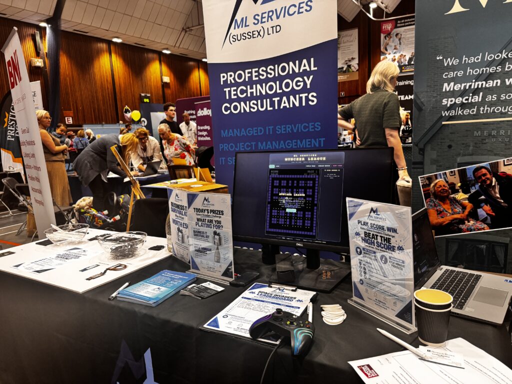 ML Services exhibition stand at the Better Business Show 2026 in Worthing, featuring the Space Invaders challenge and IT services display